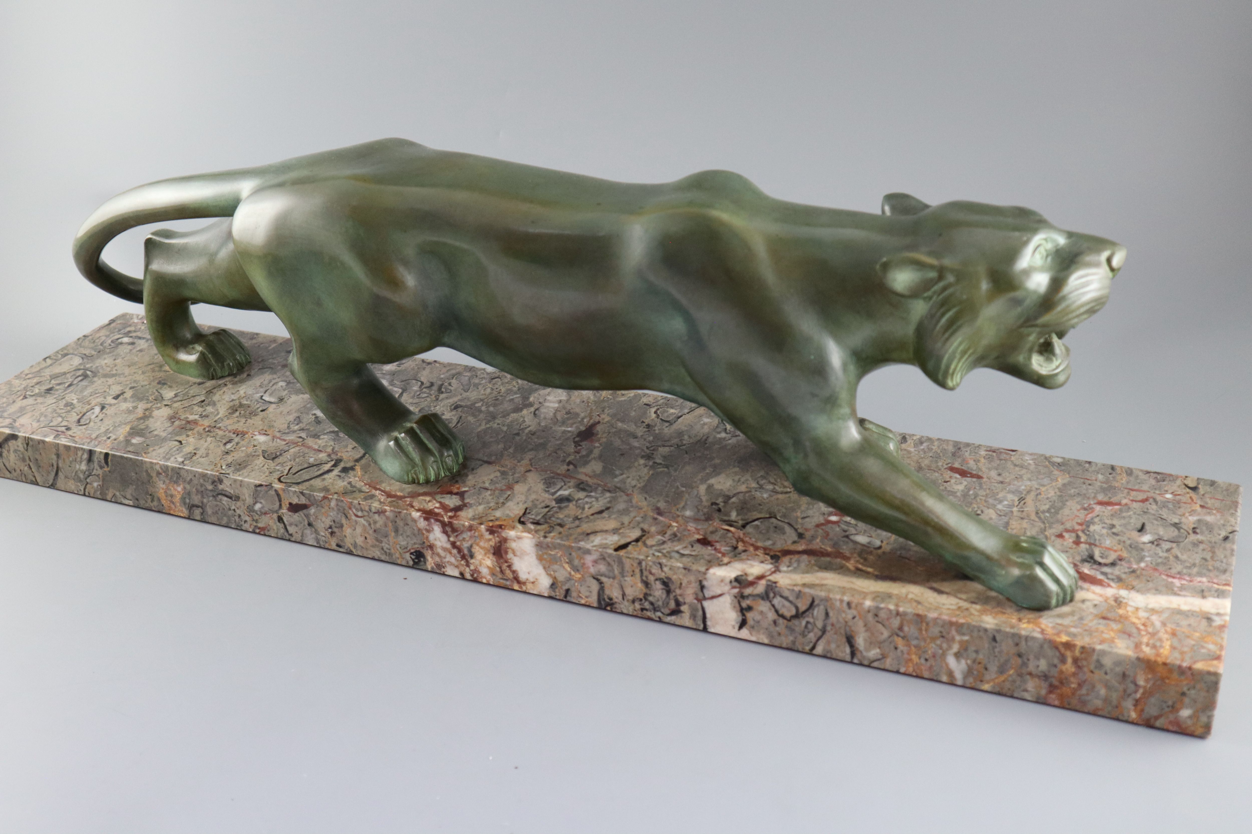 Brault. An Art Deco patinated bronze model of a prowling panther, width 29.5in. height 8.5in.